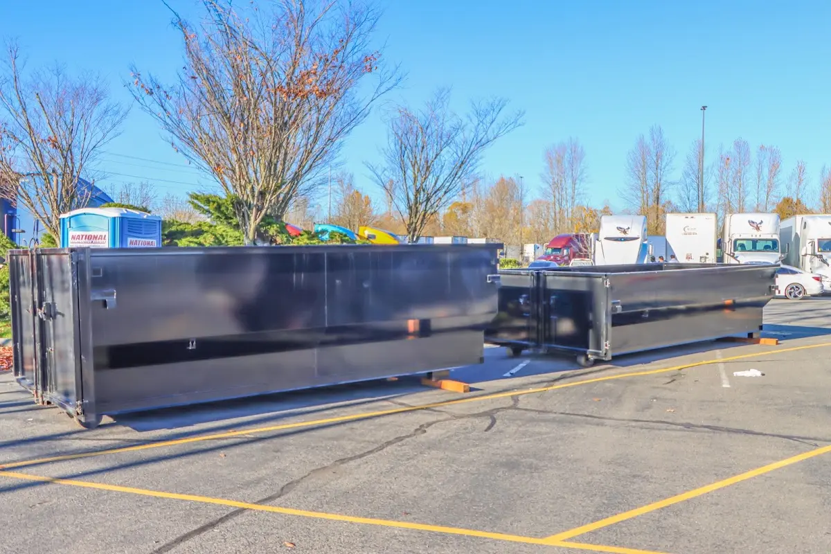 Professional dumpster rental service with roll-off container on residential driveway in Tulare